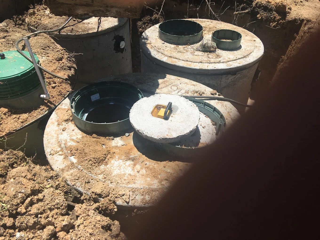 Exposed septic tank components during professional installation