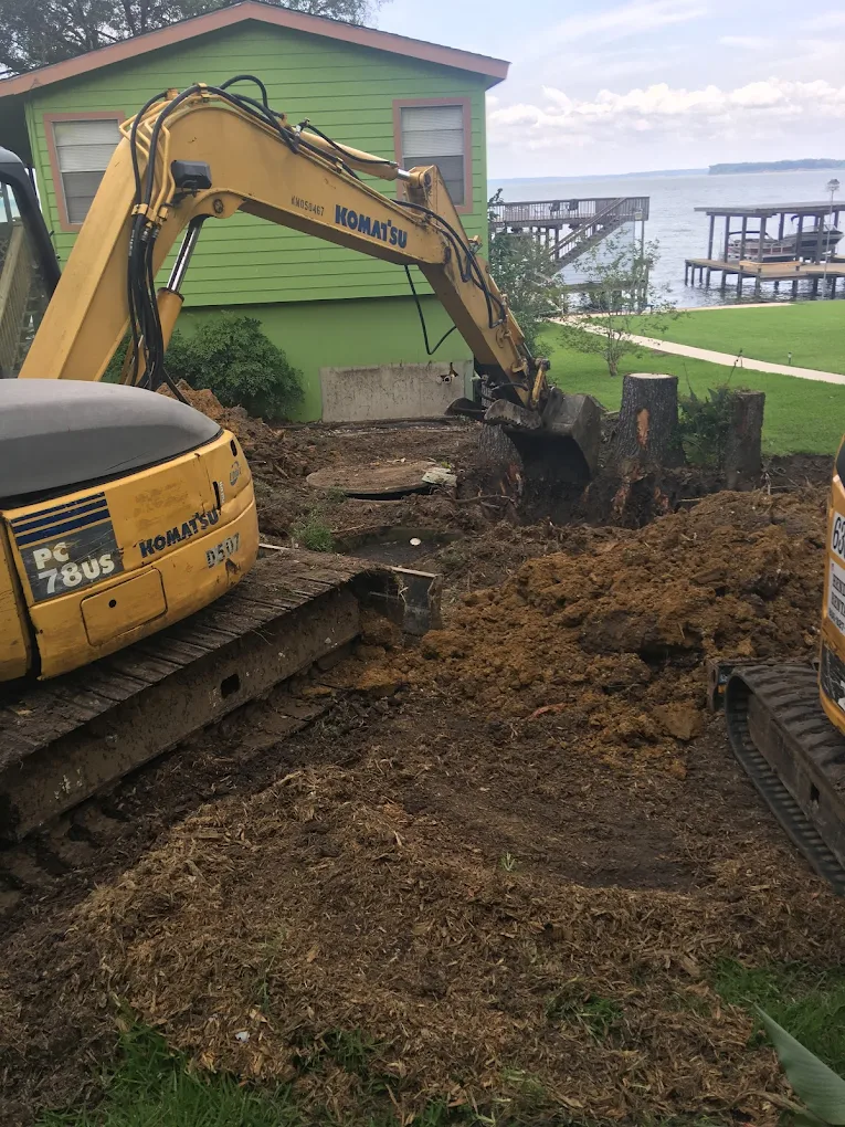 Komatsu excavator working on a lakefront septic system installation
